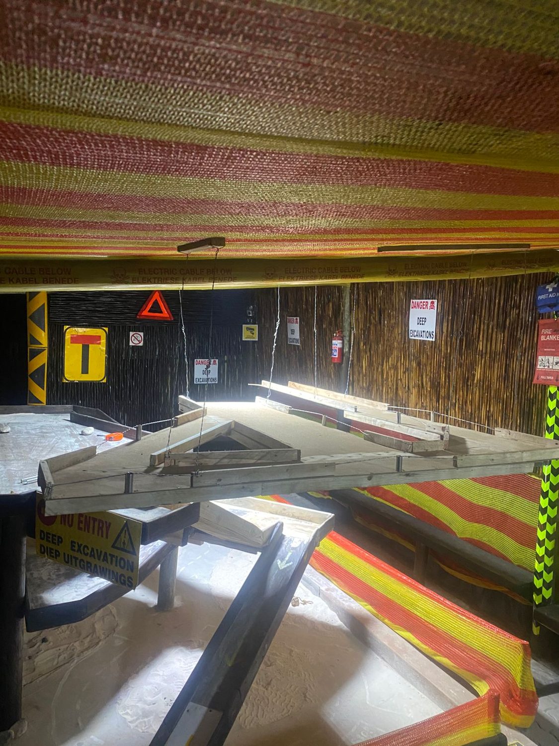 Upper track level with suspended walkways and deep excavation signs